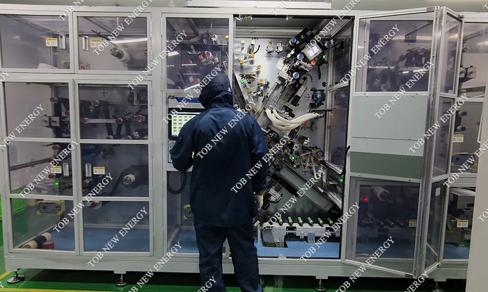 TOB engineer commissioning a 32140 tabless cylindrical cell winding machine